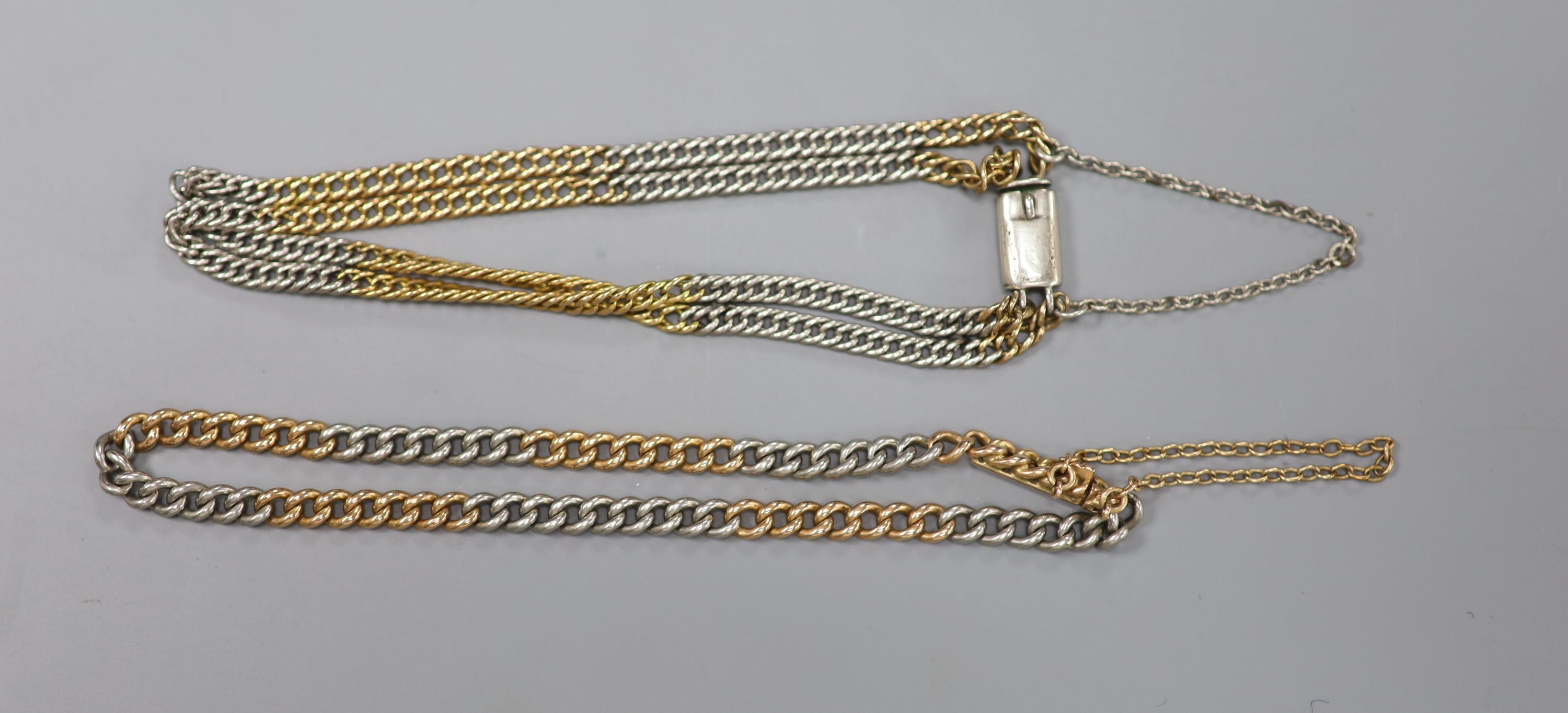 A two colour curblink bracelet, the clasp stamped 18ct, 19cm, gross 10.8 grams and one other unmarked double strand bracelet,